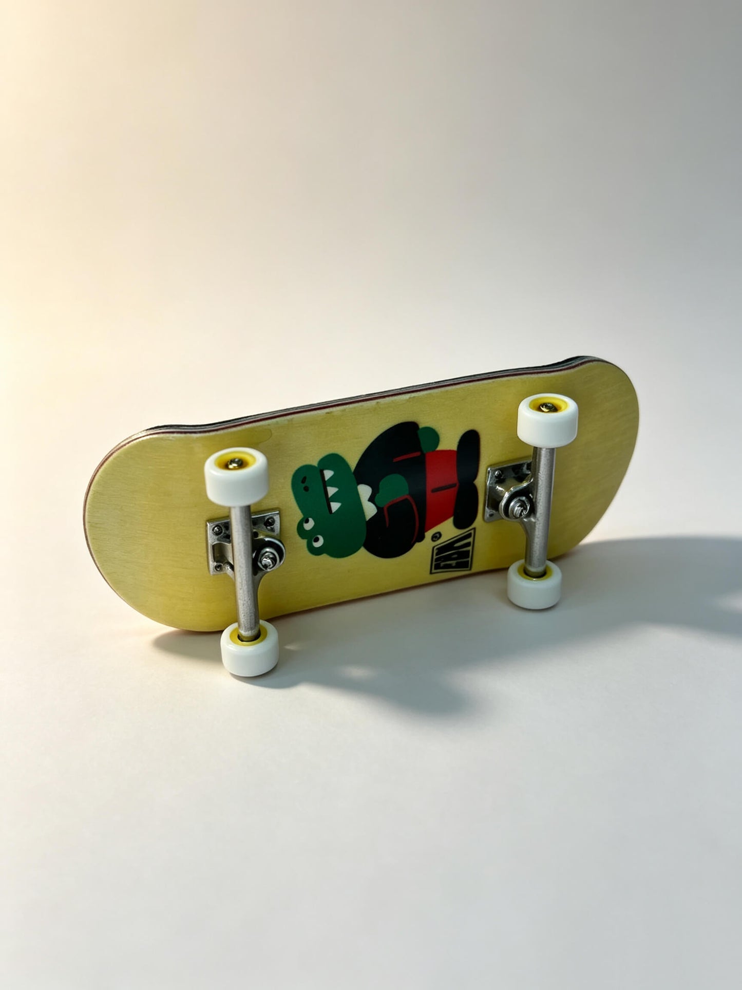 Side angle complete finger skateboard, cool crocodile art print, pro fingerboard kit