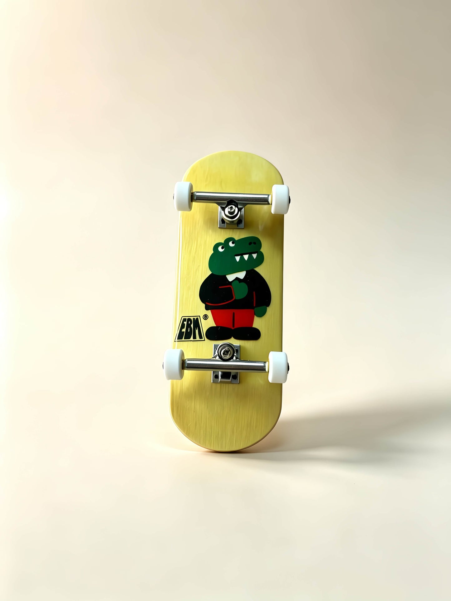 Complete wooden fingerboard with cute crocodile graphic, maple deck metal trucks white wheels