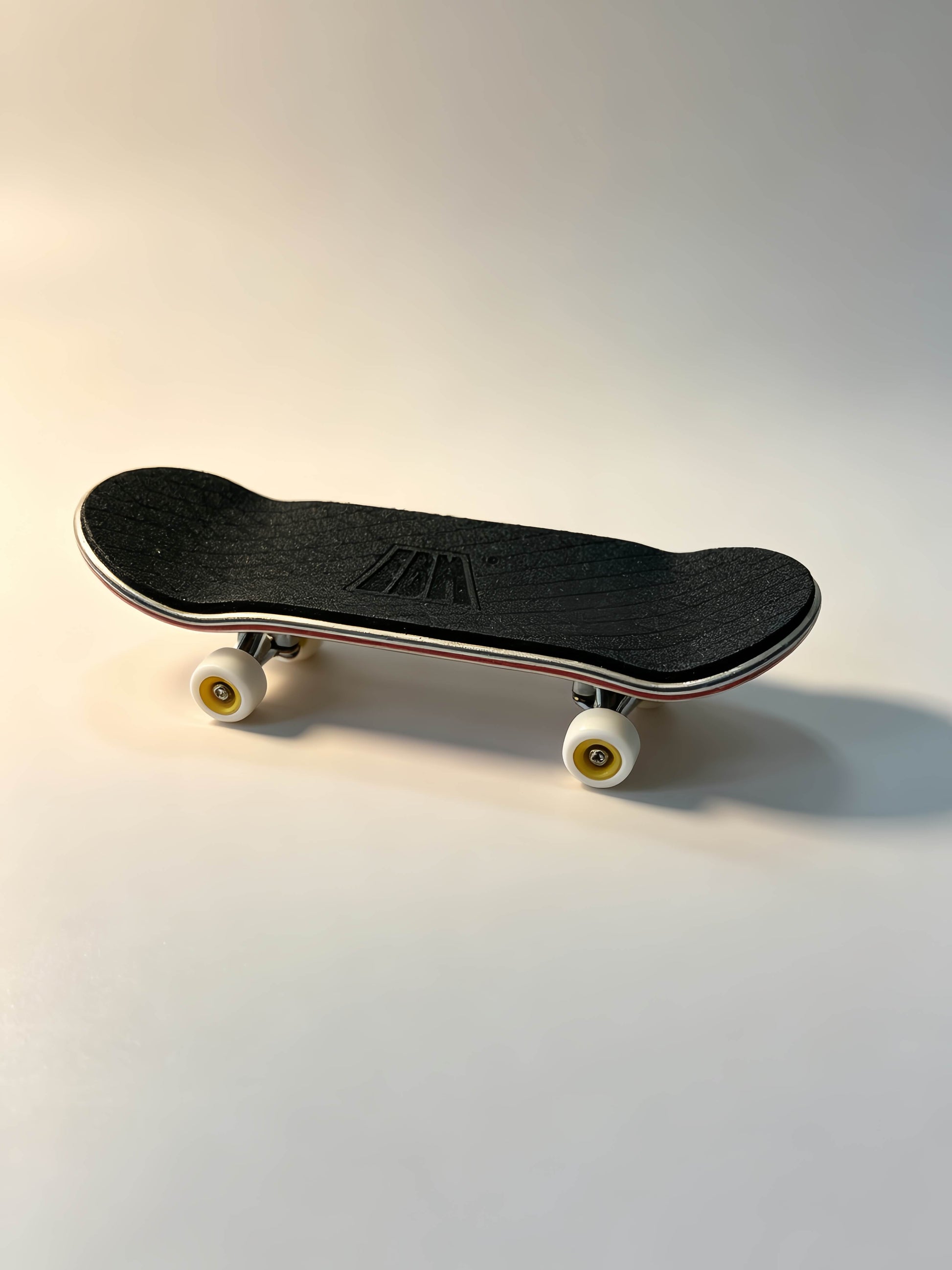 Wooden fingerboard top view, black grip tape, maple finger skateboard deck